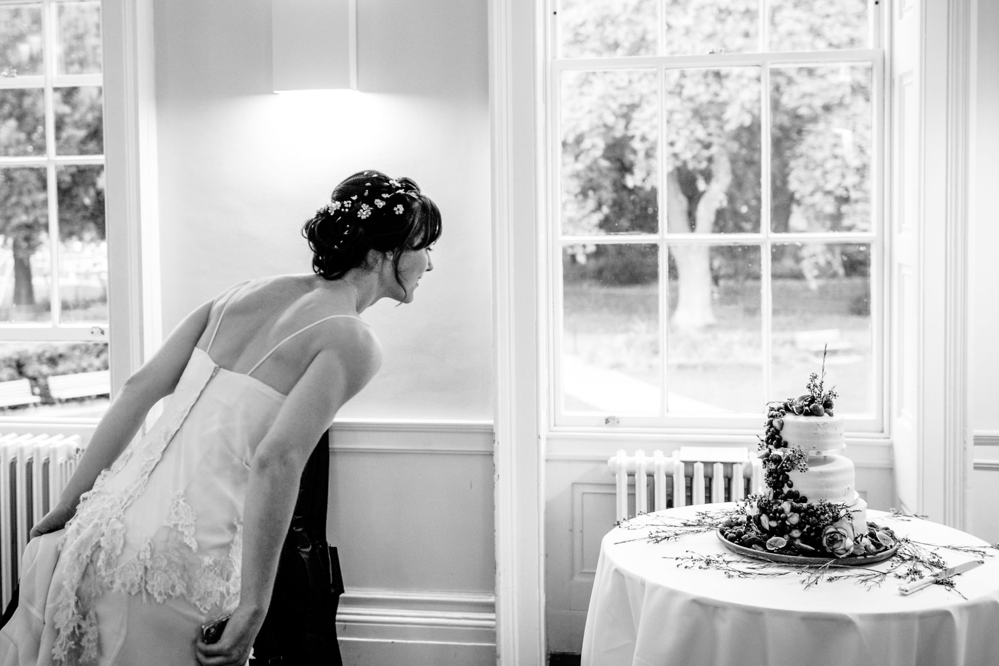Clissold House wedding bride checking on the cake