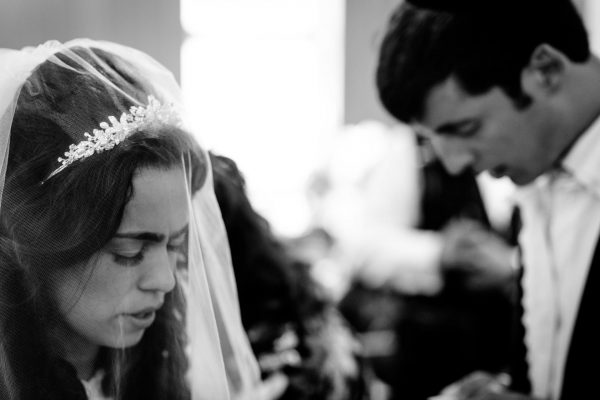 Jewish Wedding Photographer walks around the groom under chuppah