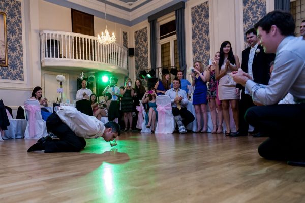 Greek Wedding Photo of groom drinking whiskey from the floor dance