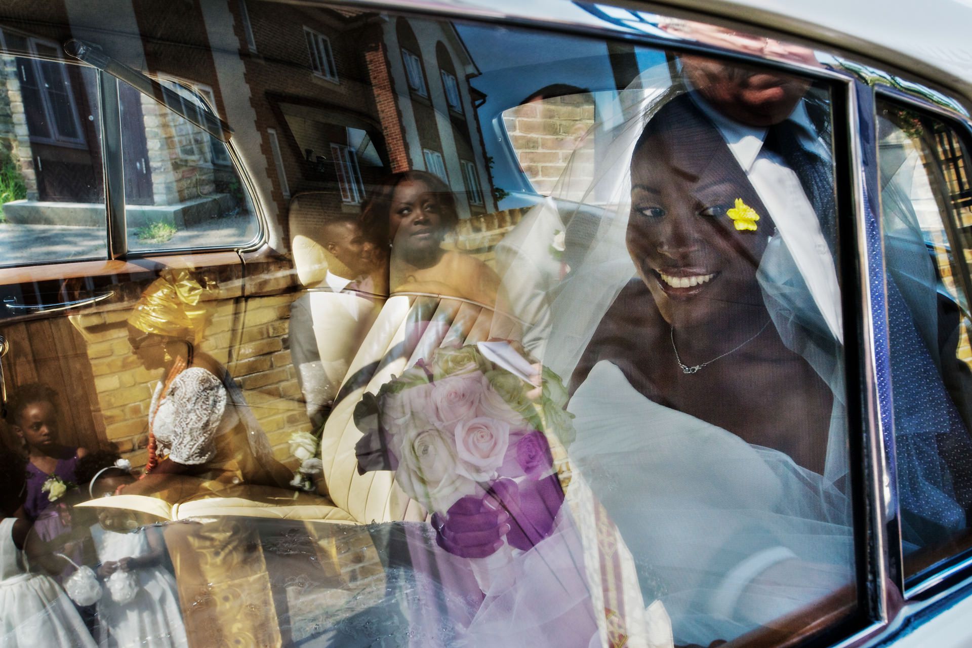 Nigerian wedding bride in the car behind the glass window