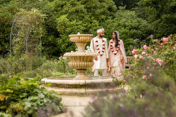Asian Married couple posing ar Bhaktivedanta Manor