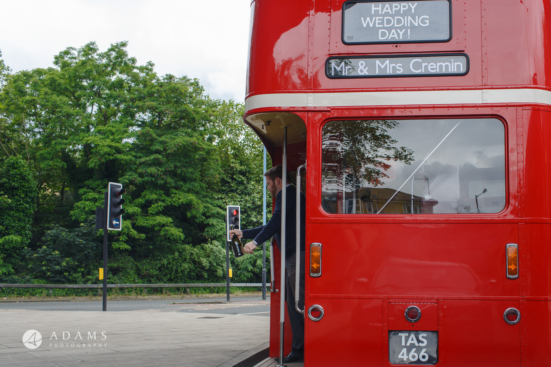 Guess is opening champagne on the bus picture taken by wedding photographer