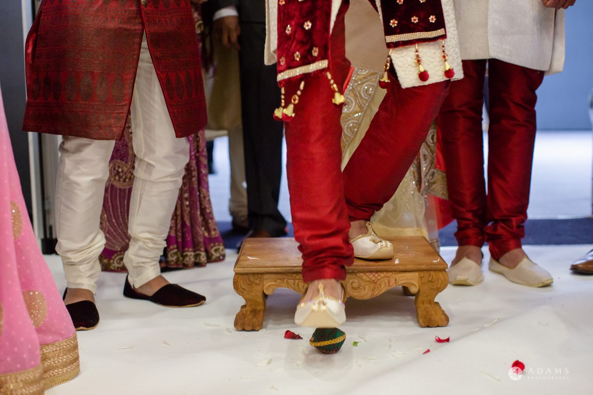 Hilton London Syon Park Asian Wedding groom breaks the coconut
