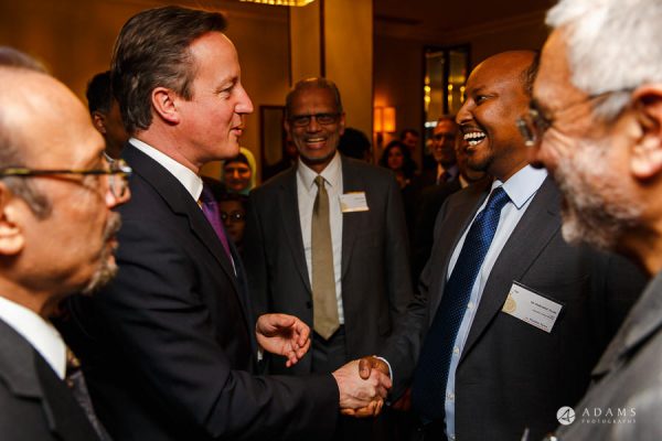 London event photographer David Cameron shaking hands at the conference