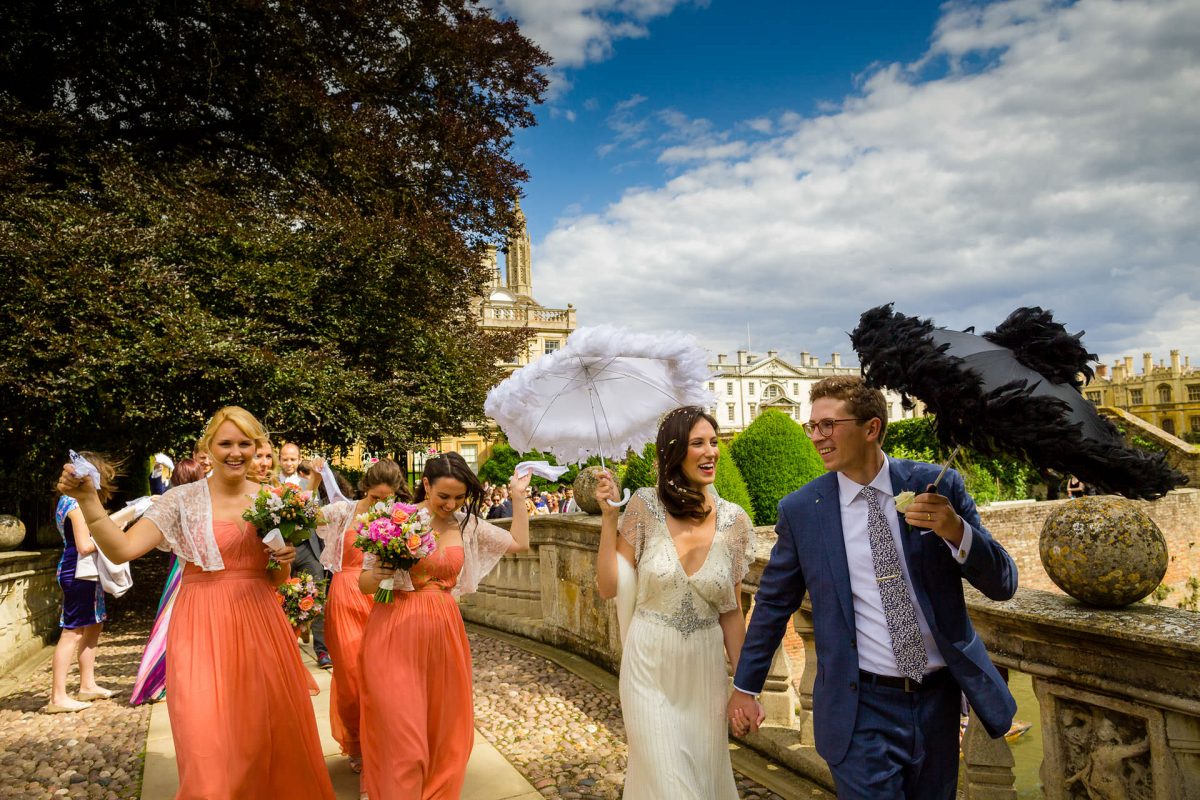 Best wedding photographer London happy married couple walking with bridesmaids