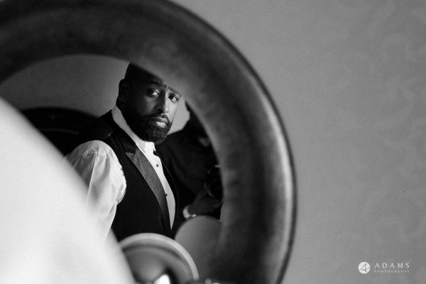 syon park house wedding groom looking in the mirror Photography
