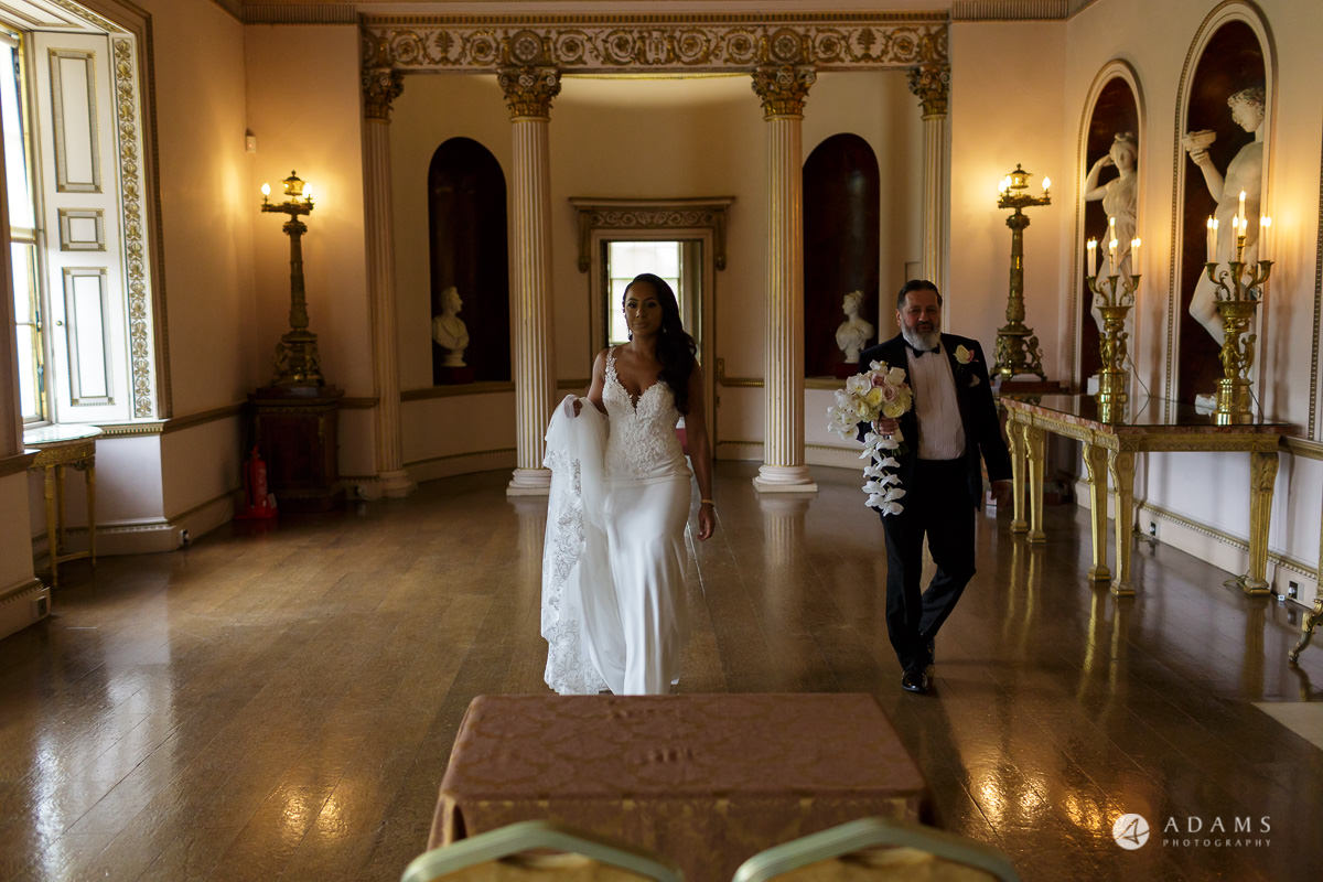 syon park house wedding bride walks with her father