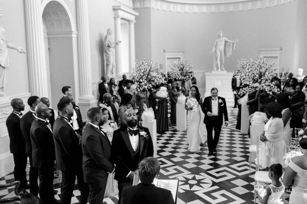 syon park house wedding groom is having an emotional moment while the bride is walking down the aisle wth her father