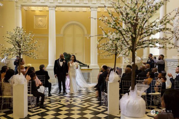 syon park house wedding bride and groom walks out the venue