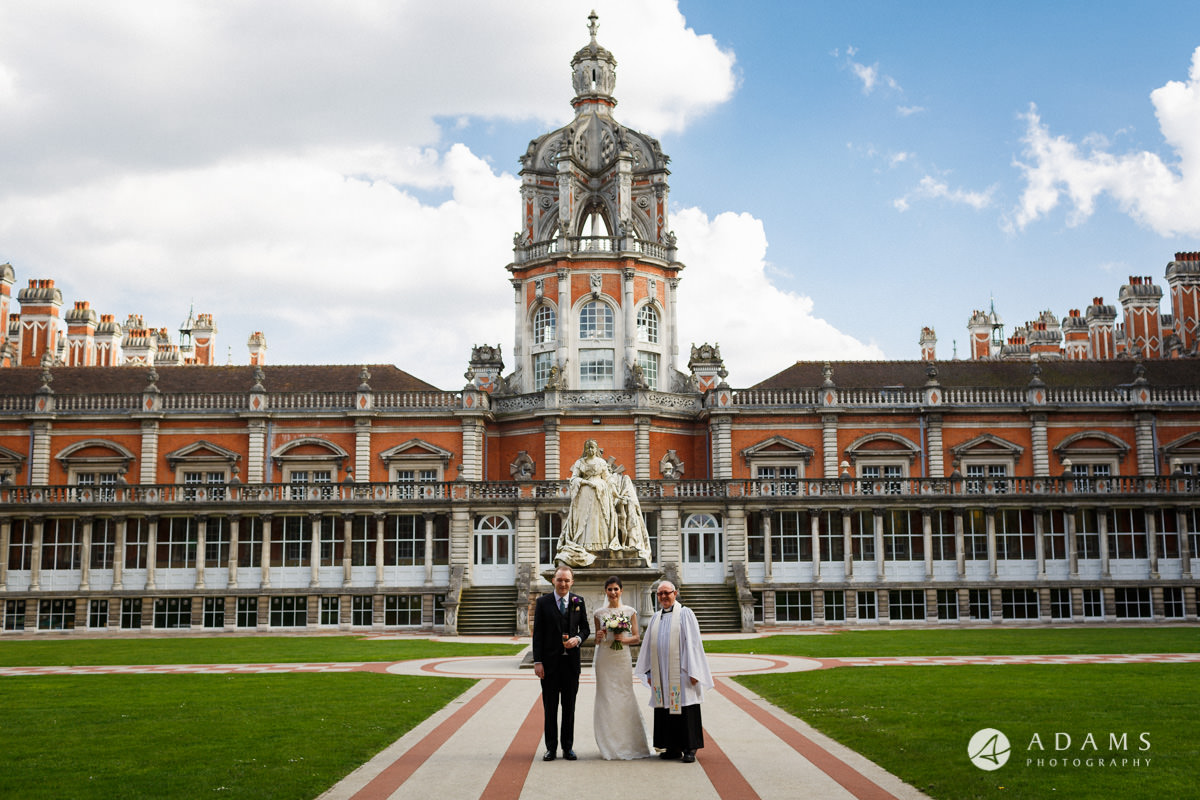 Royal Holloway wedding photo with the priest in the courtyard