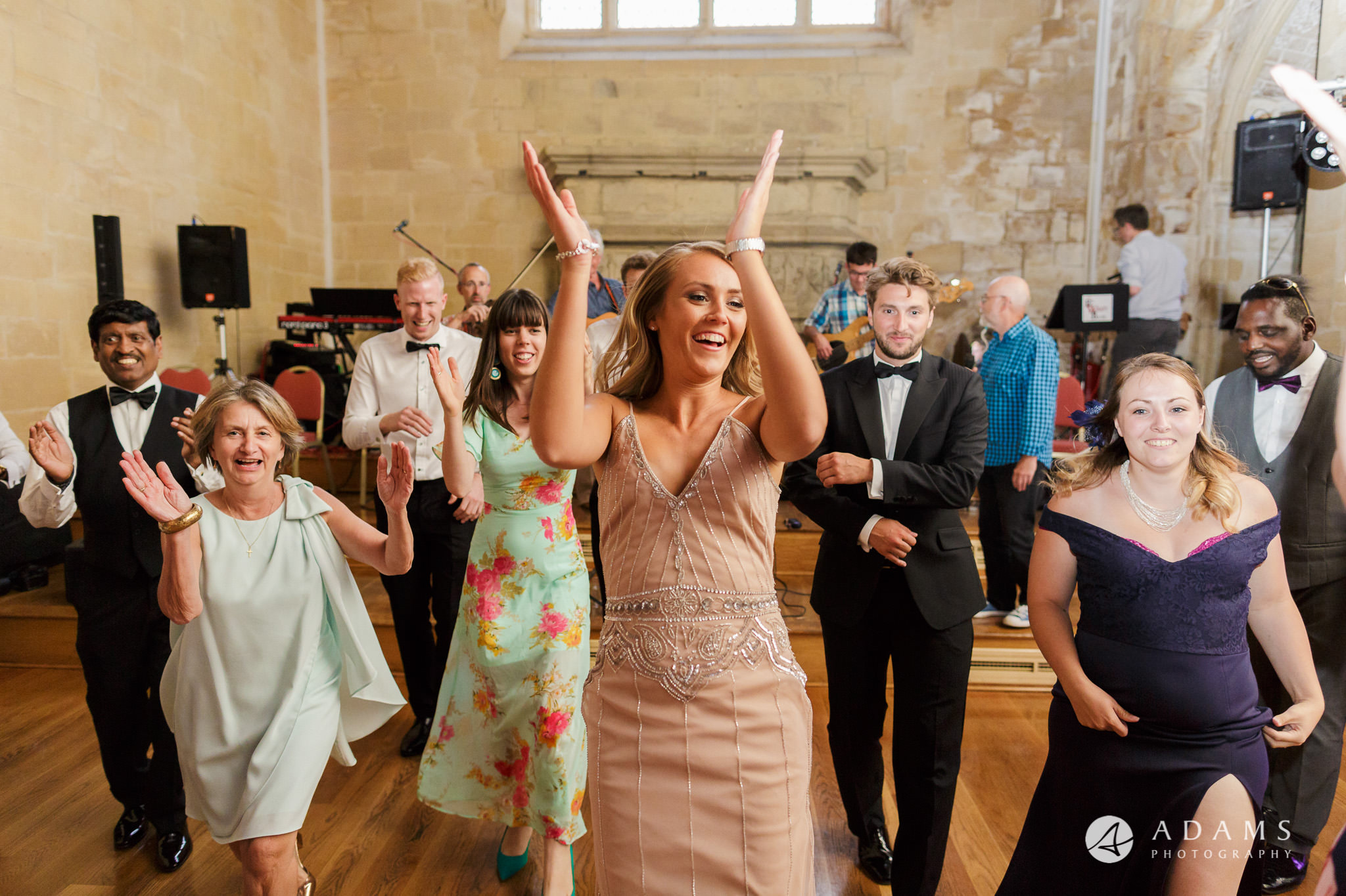 bridesmaid is dancing and clapping her hands