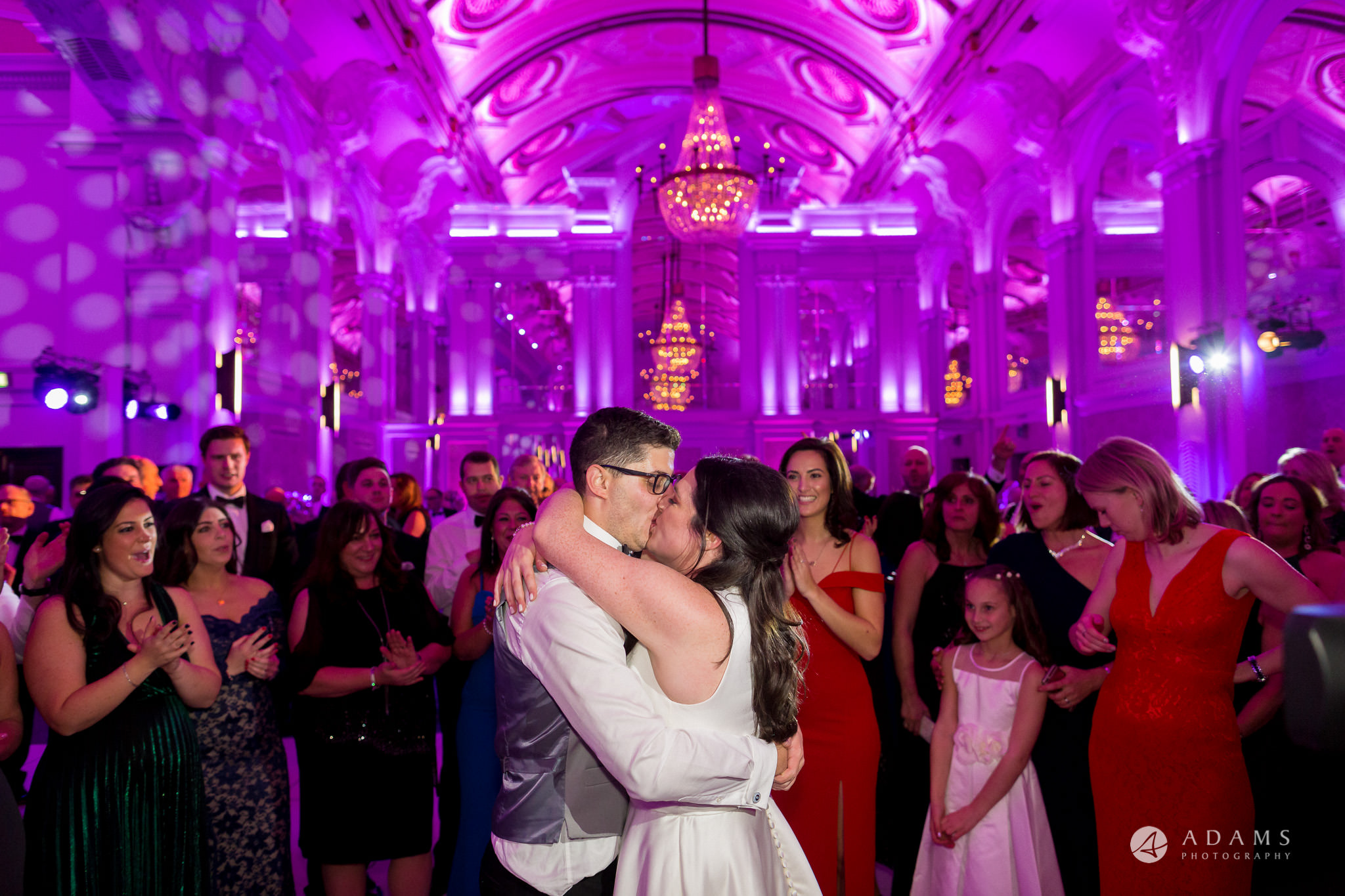 grand connaught rooms wedding couple hugging and kissing in the center of the room