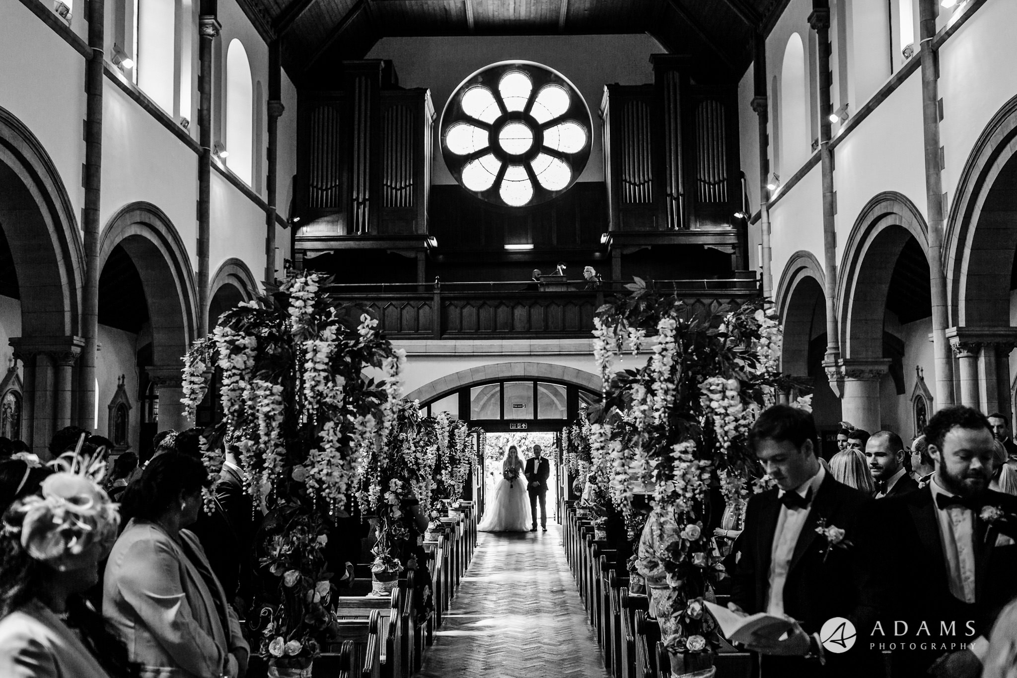 black and white wedding photography bride walks down the isle