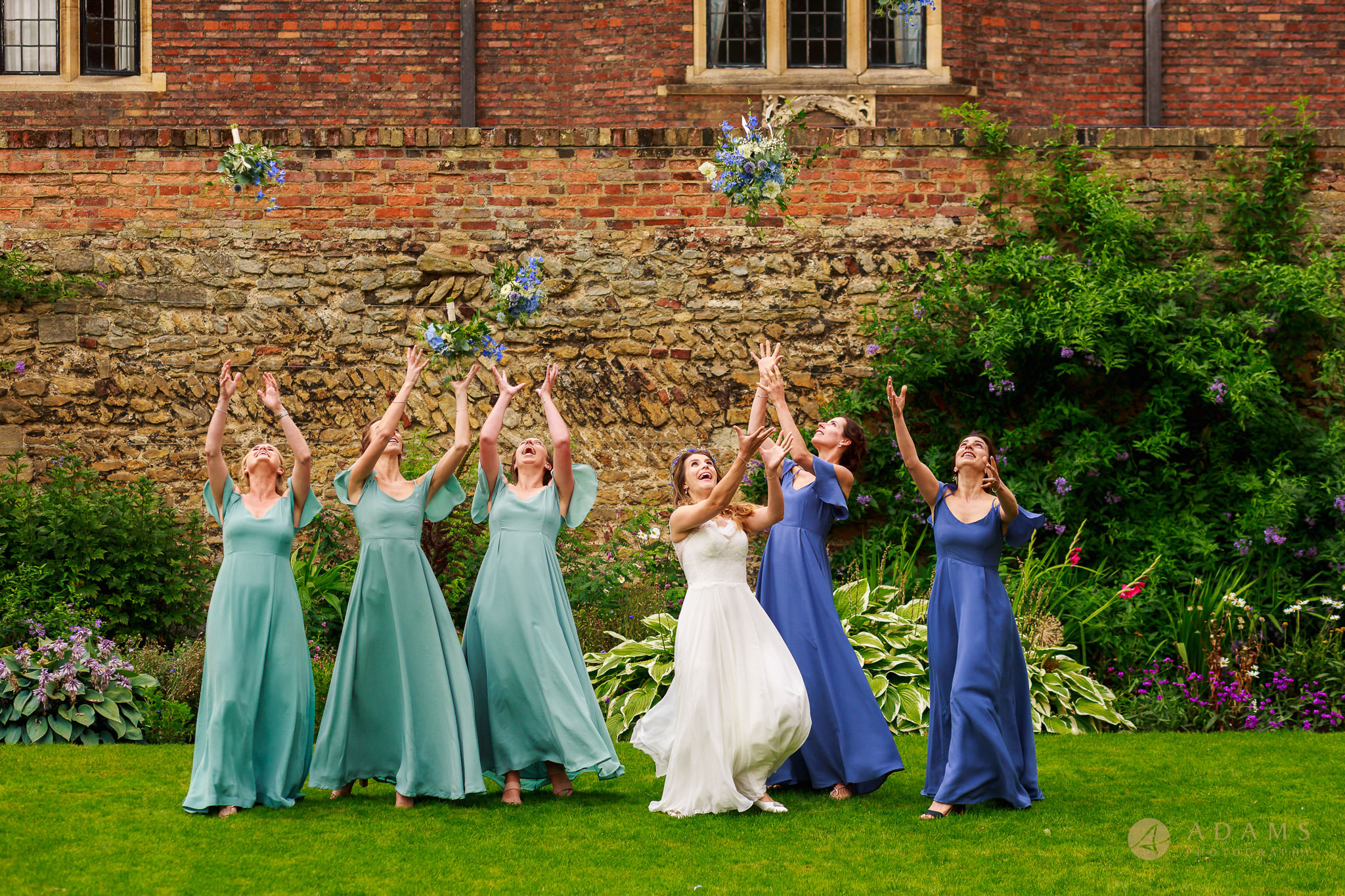 bride and bridal party tossing their bouquets