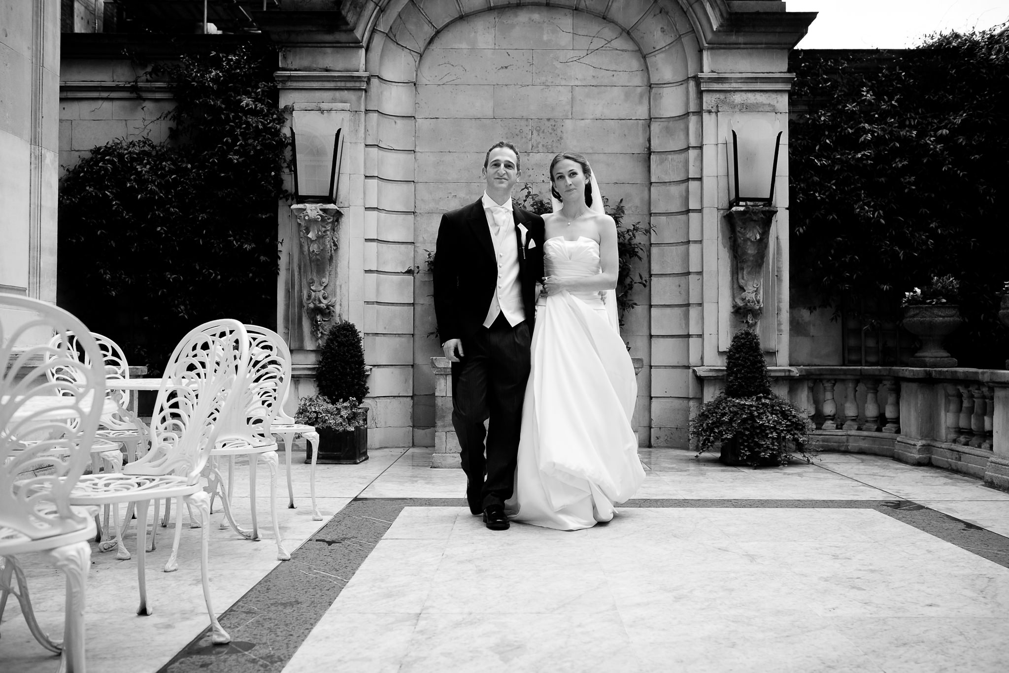bride and groom walk together in the patio