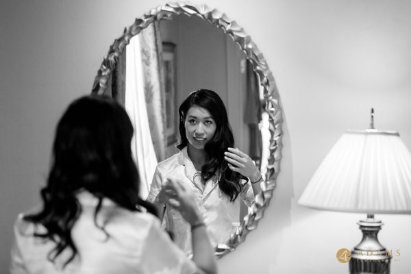 Bride checking her makeup in the mirror