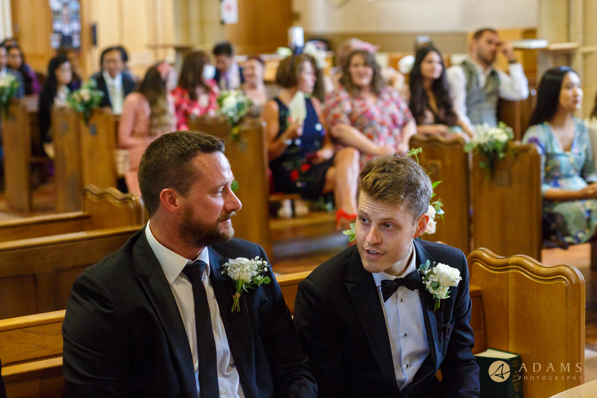 groom chats with his best man in the church in Marlow