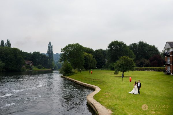 Compleat Angler Wedding Photographer taking phot of the couple walking