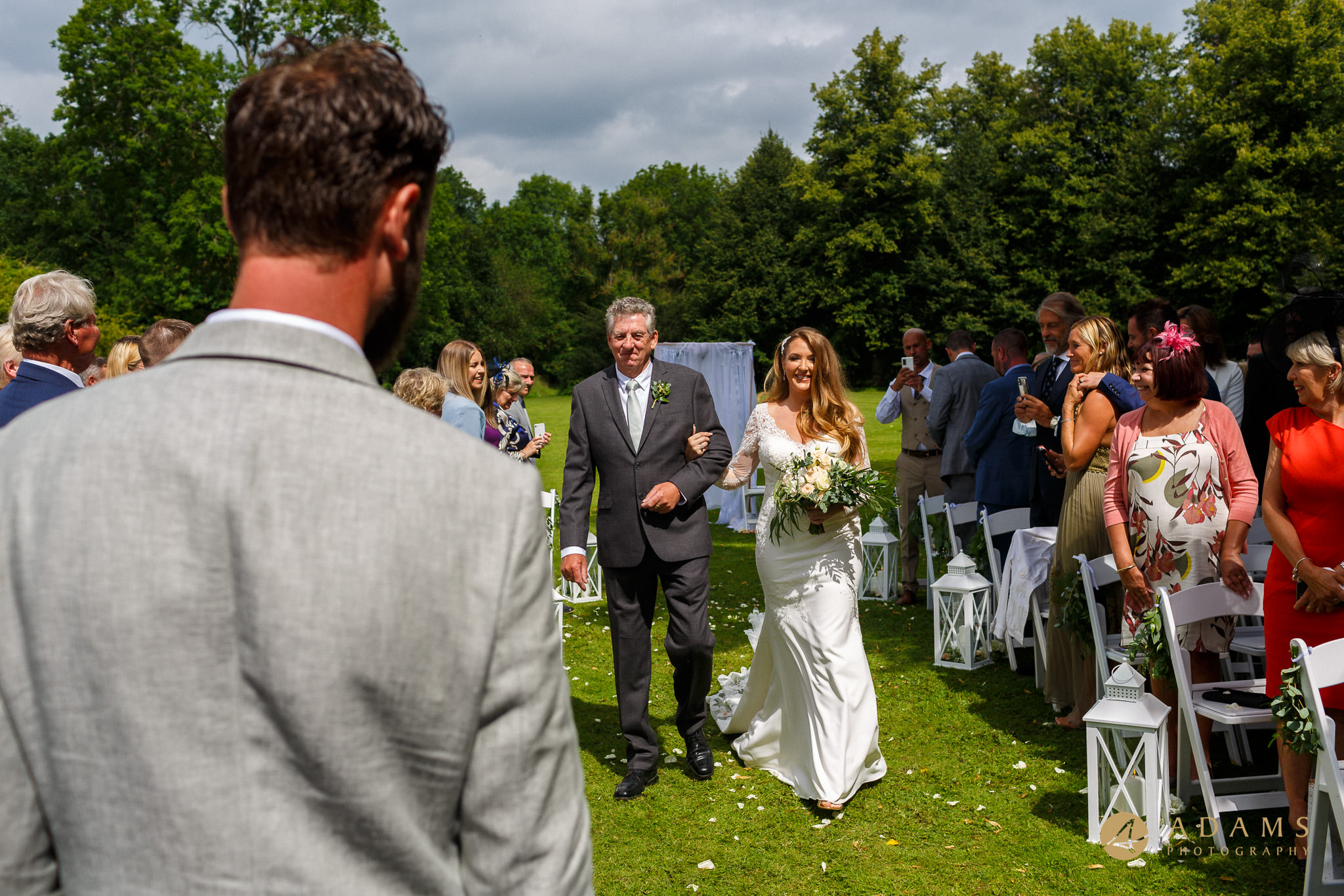 bride walks with her dad down the aisle