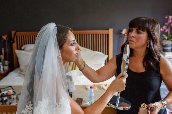 bride checking the make up in the mirror
