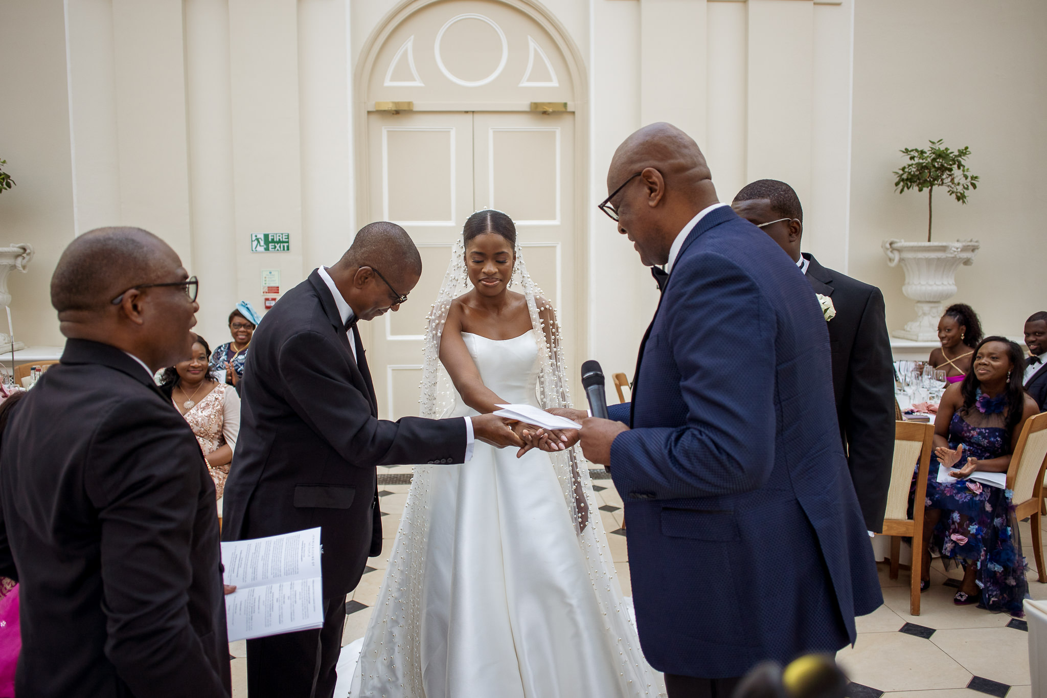 father of the bride gives her hand to the groom