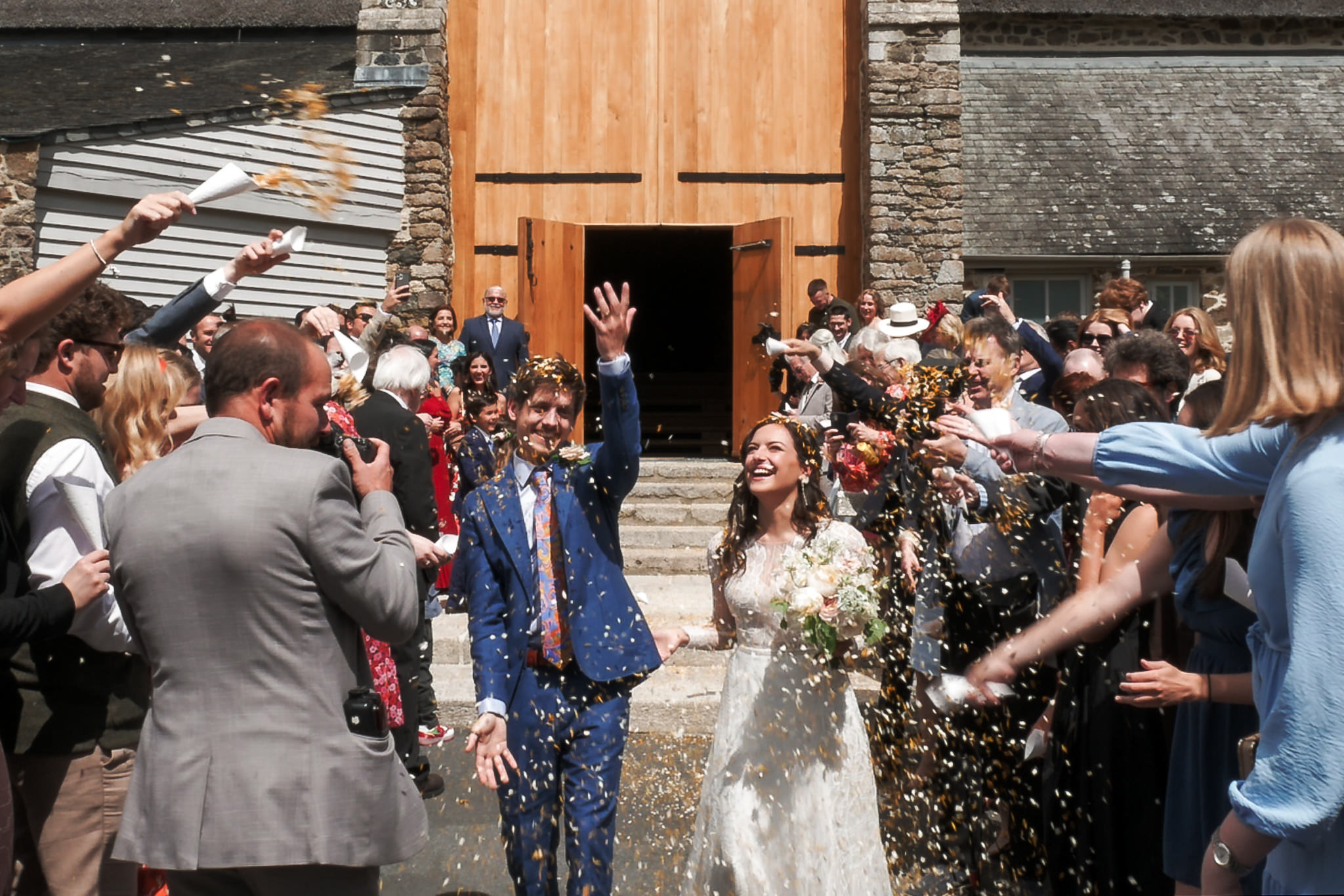 The Great Barn Devon Wedding Videographer Confetti Shower in front of the barn