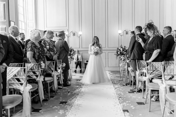 Bride walking down the sill at Gosfield Hall