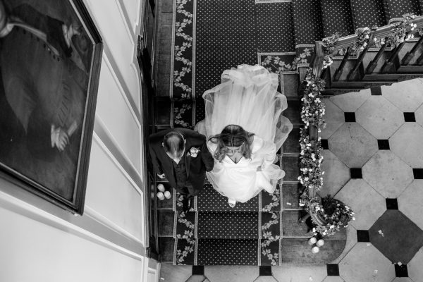 Veie of the bride and groom form above there staircase