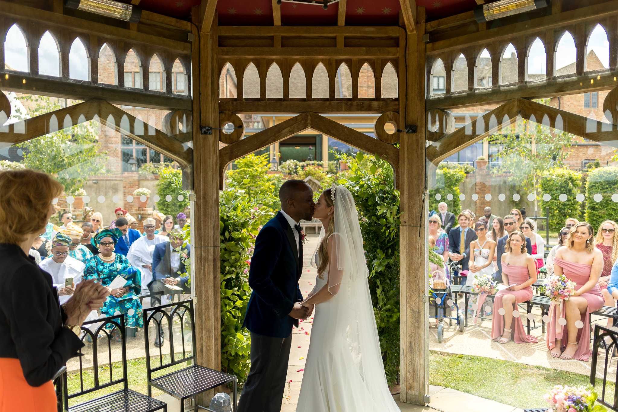 bride and groom kissing inside of the pavilion at Old Hall Ely Wedding