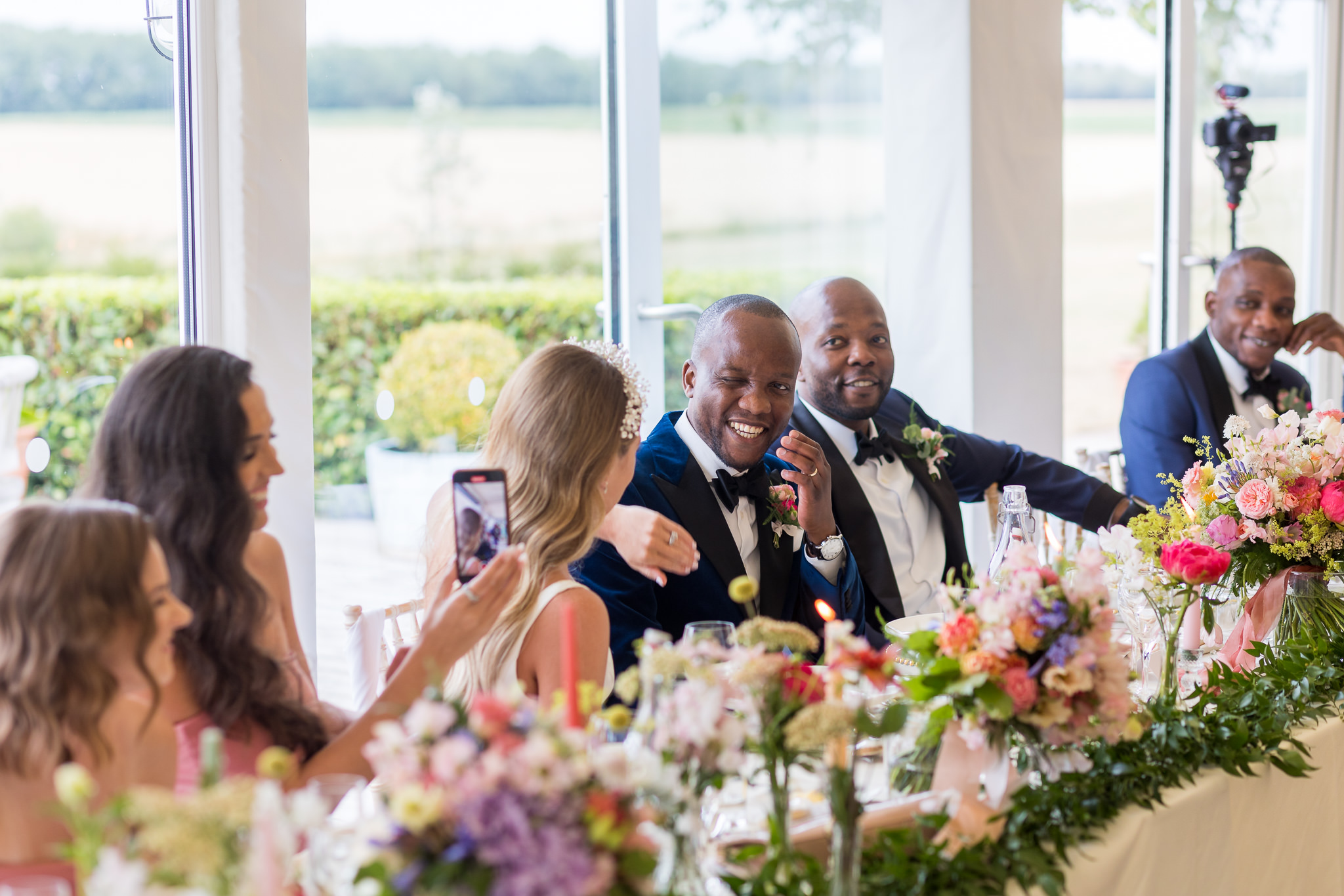 Top table with groom laughing