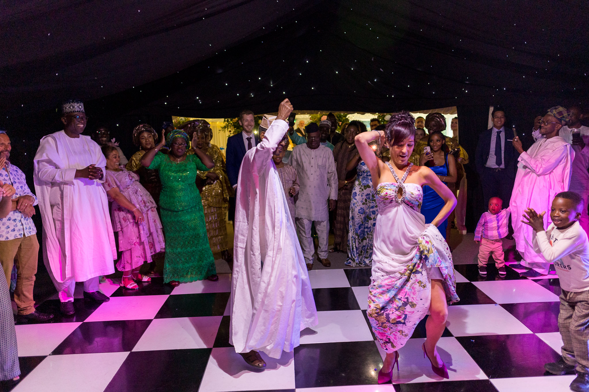 some wedding guests dance on the dance floor