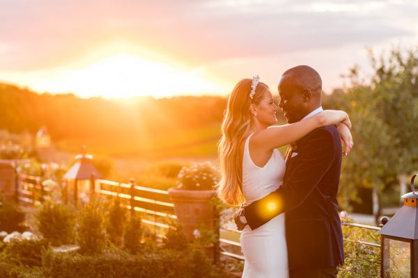 bride and groom kissing and hugging at the magic hour