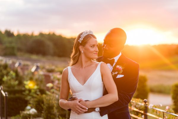 Married couple posing at sunset at The Old Hall Ely
