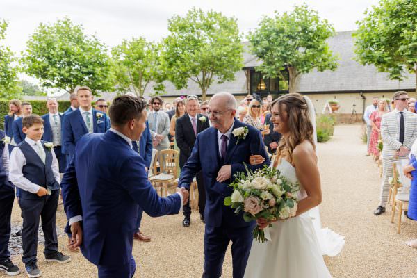 Father of the bride shakes grooms hand