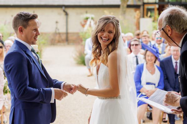 Bride is laughing at Bury Court Barn Wedding Ceremony