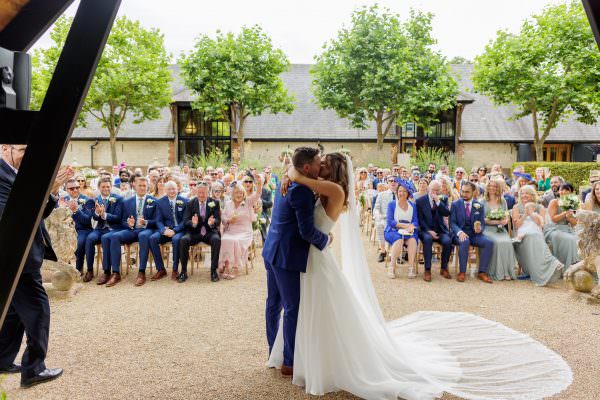 First kiss of the newly weds at their Bury Court Barn Wedding