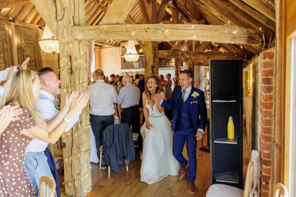Big entrance of the married couple to the wedding breakfast at Bury Court Barn Wedding