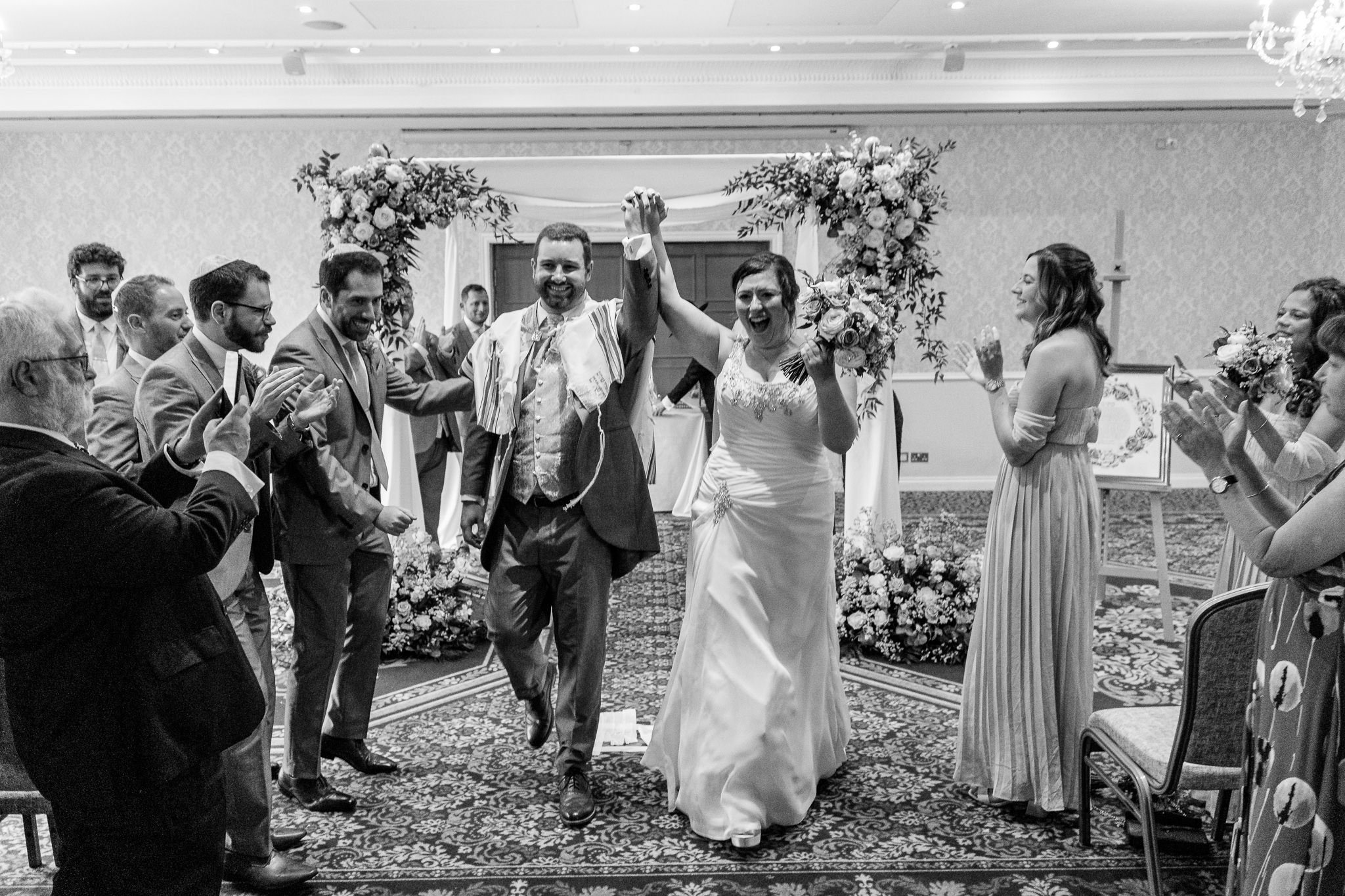 Married coupel holding their hand in the air at Shendish Manor