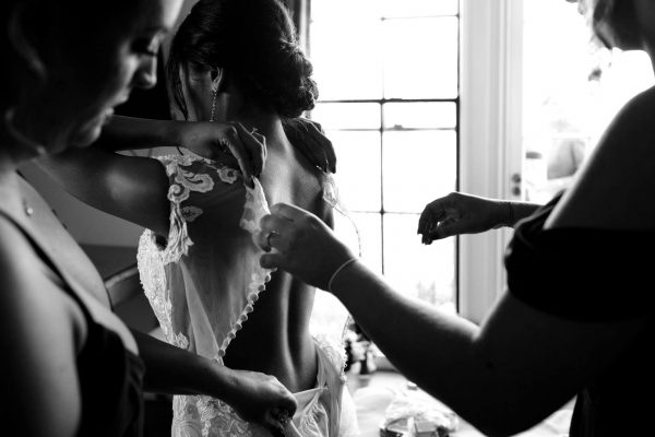 Bride getting in to her wedding dress