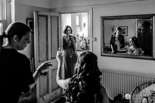 bridesmaids assisting the bride during the getting ready