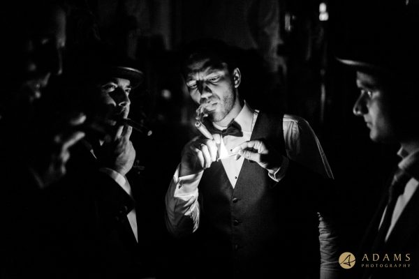 Groom and groomsmen smoking cigars