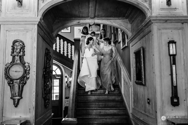 bride and bridesmaids walking down the stairs