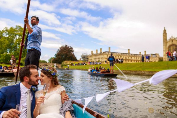 Cambridge Wedding Photographer married couple punting in from of the Clare College