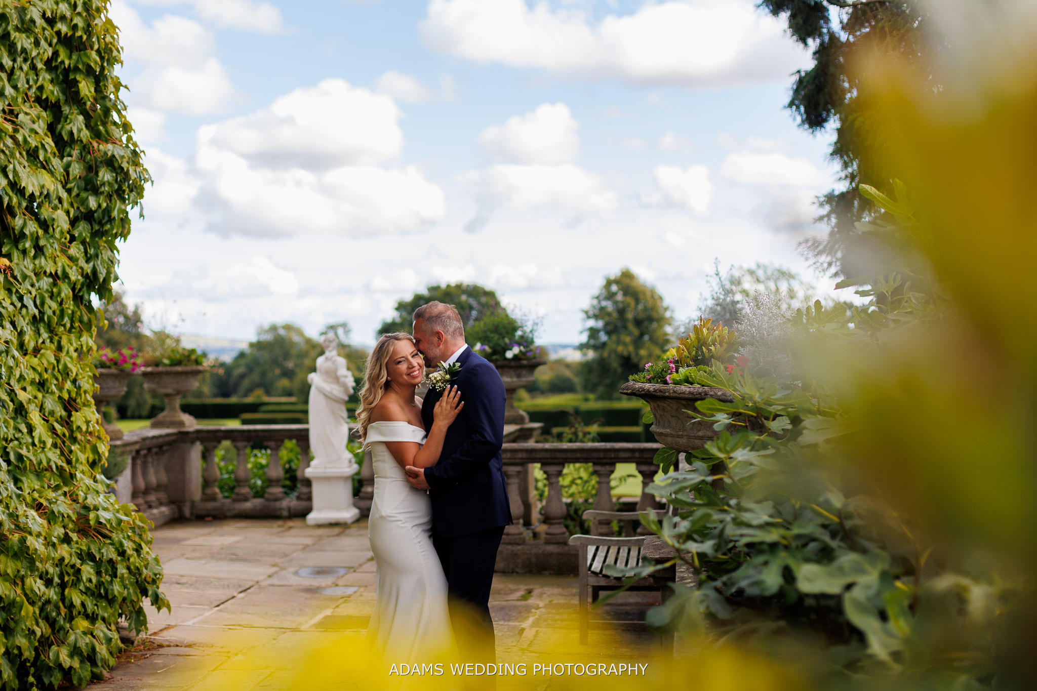 Eastwell Manor Ashford Wedding Photographer taking photo of married couple