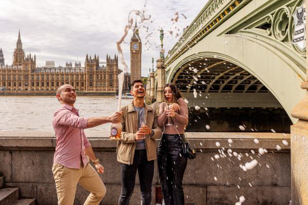 champagne opening after the proposal in front of Big Ben in London