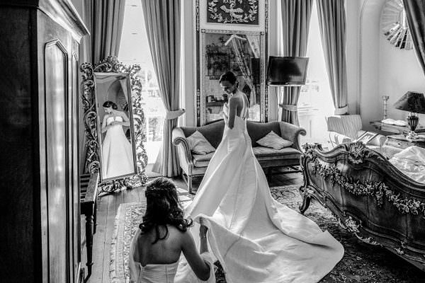 bride is getting ready putting a dress