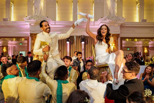 Bride and Groom on the chairs during dancing at their London wedding