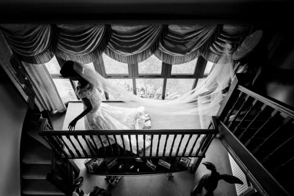 Bride walking down the staircase before leaving home for her wedding