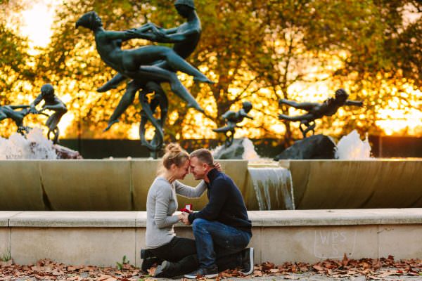 the moment just after the surprise proposal in Hyde Park London, the couple hugging themselves