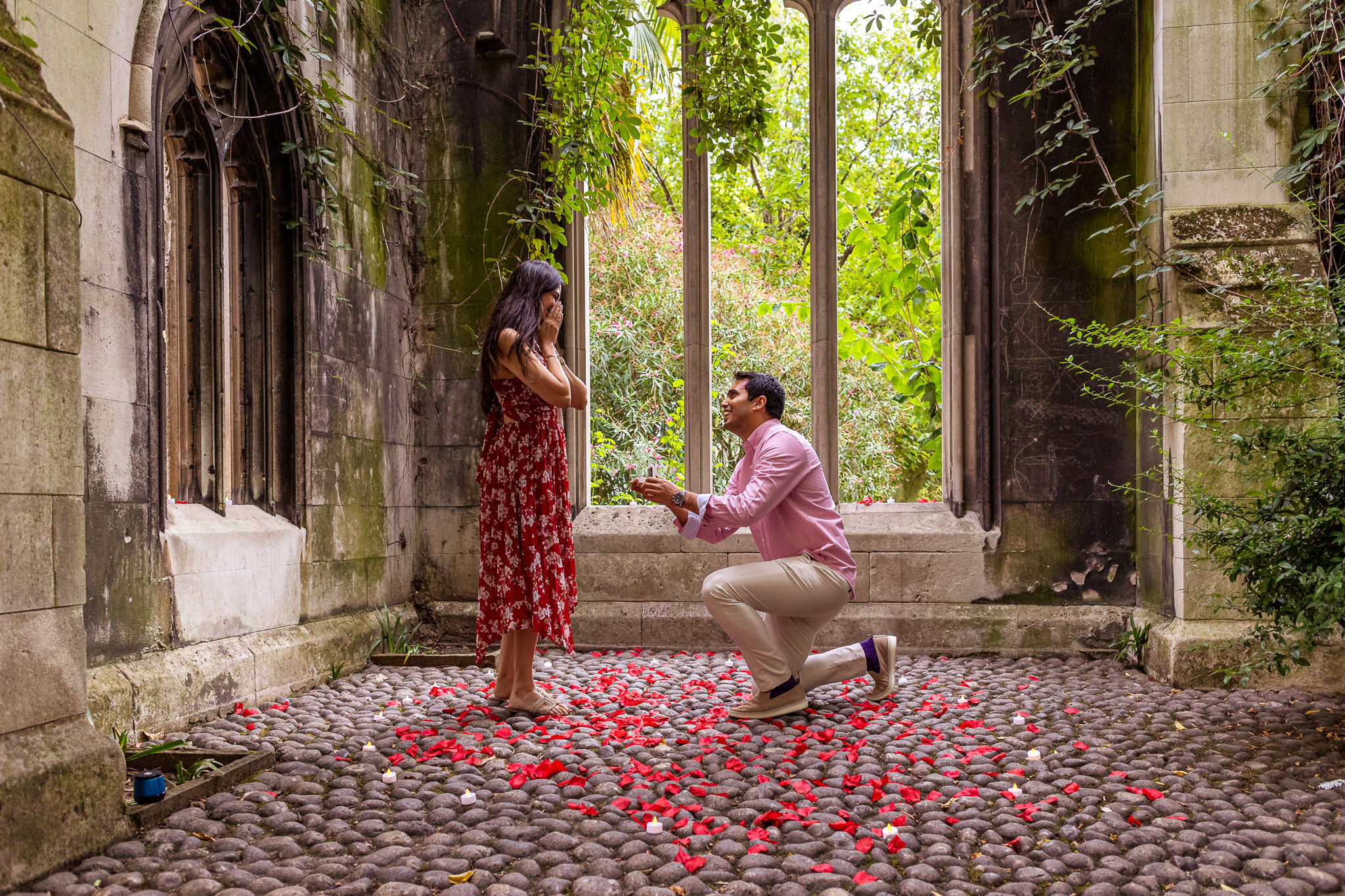 A boyfriend is dropping to one knee for a proposal at St Dunstan in the East Church Garden